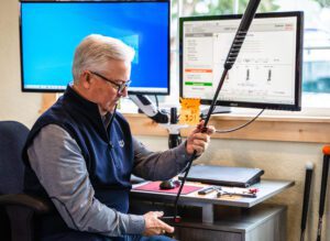 Man is examining the grip of the golf club